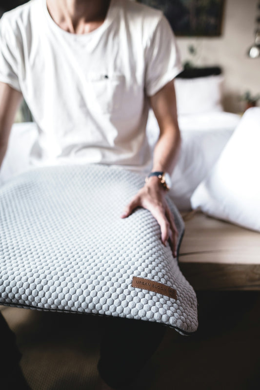 person holding grey mat inside room