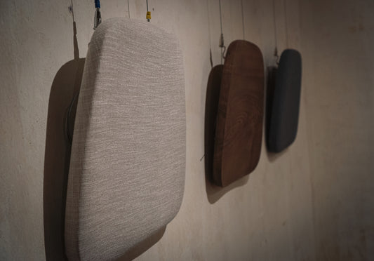 a pair of brown shoes on a white wall